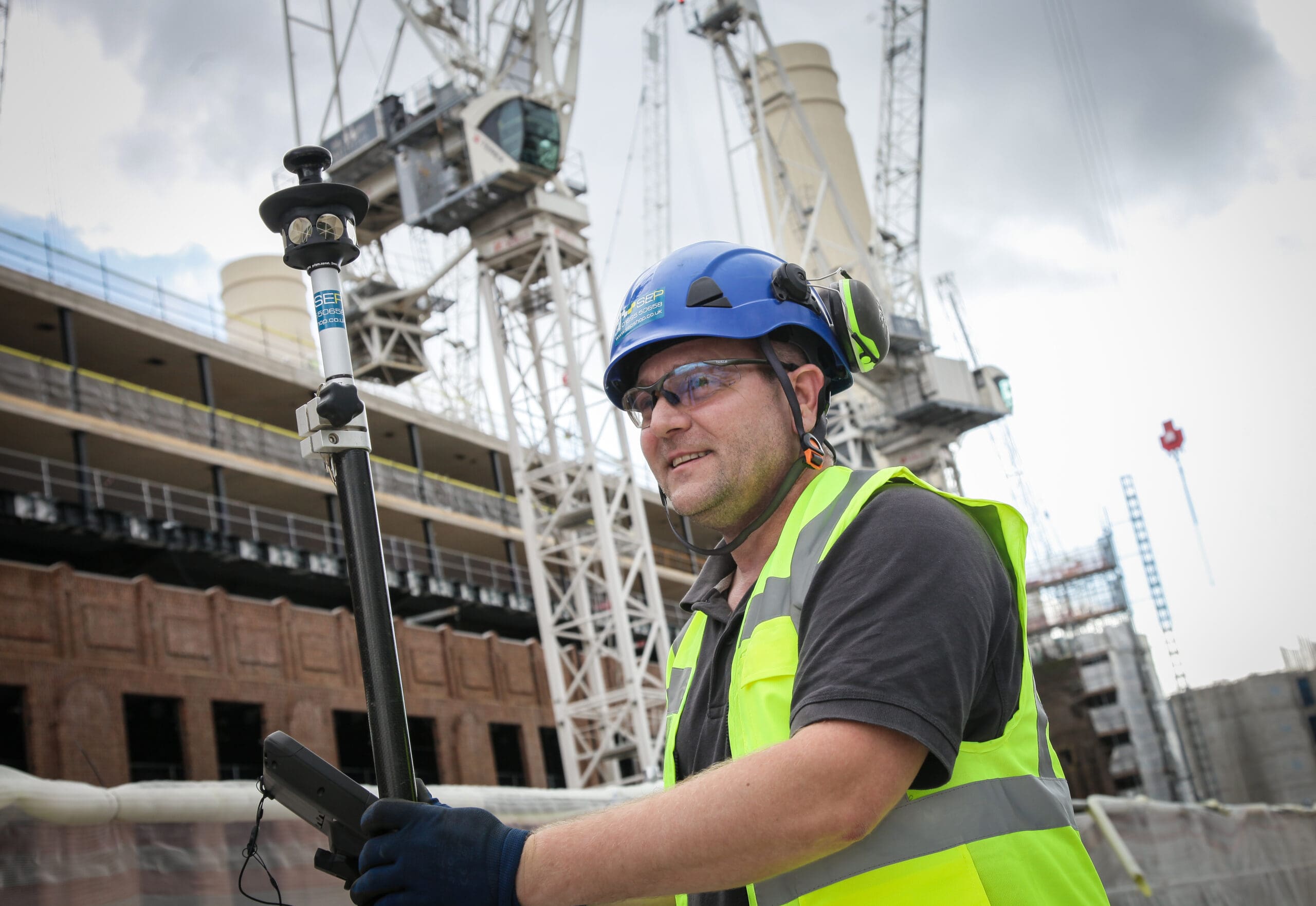 Setting out engineer in Ealing marking site layout for construction